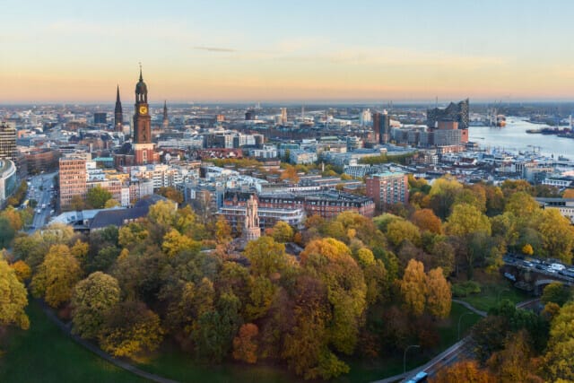 View of Hamburg with Michel, harbor, and New Elbphilharmony on sunset in autumn.